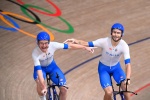 Italy's Simone Consonni (L) and Italy's Filippo Ganna celebrate after winning gold and setting a new World Record in the men's track cycling team pursuit finals during the Tokyo 2020 Olympic Games at Izu Velodrome in Izu, Japan, on August 4, 2021. (Photo 