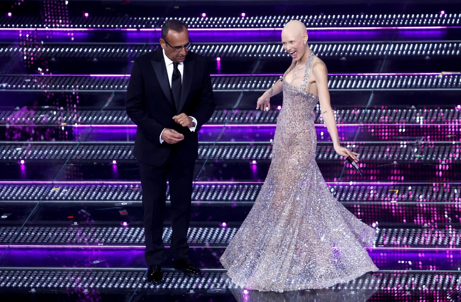 Sanremo Festival host and artistic director Carlo Conti (L) and Italian model Bianca Balti (R) on stage at the Ariston theatre during the 75th edition of the Sanremo Italian Song Festival, in Sanremo, Italy, 12 February 2025. The music festival will run f