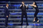 (L-R) Sanremo Festival host and artistic director Carlo Conti, Italian singers Achille Lauro and Elodie on stage at the Ariston theatre during the 75th edition of the Sanremo Italian Song Festival, in Sanremo, Italy, 14 February 2025. The music festival w