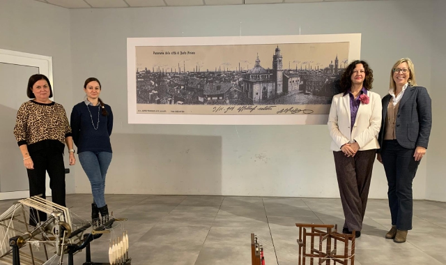 Sulla parete un ordito Jacquard che rappresenta le Cento Ciminiere di Busto Arsizio